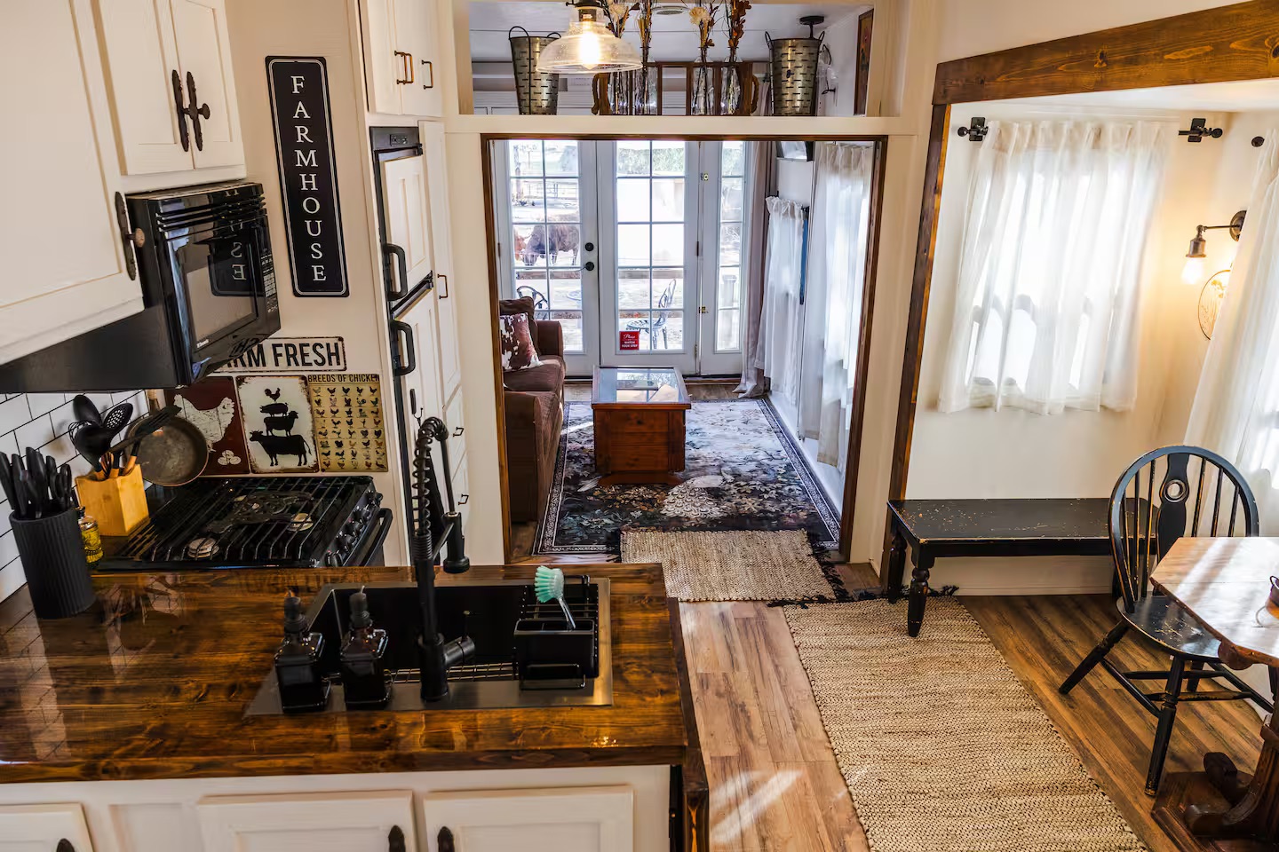 Bright rustic interior of The Roost with kitchen, dining nook, and living space